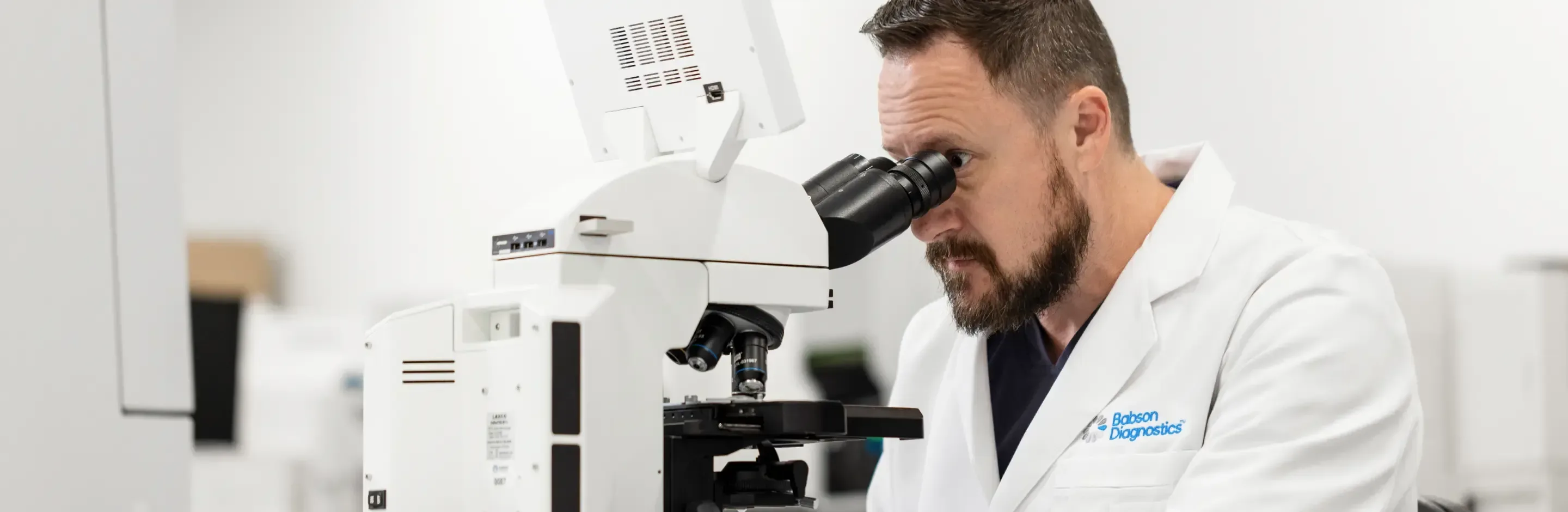 scientist looking through a microscope